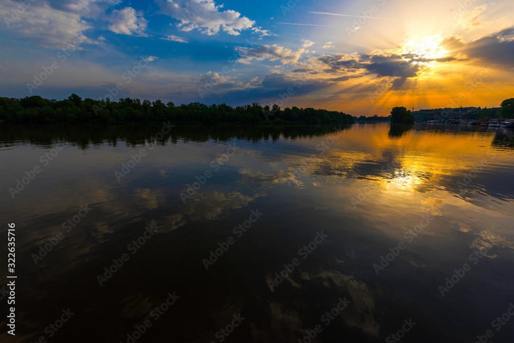 Fototapeta premium Dawn on the river with clouds..