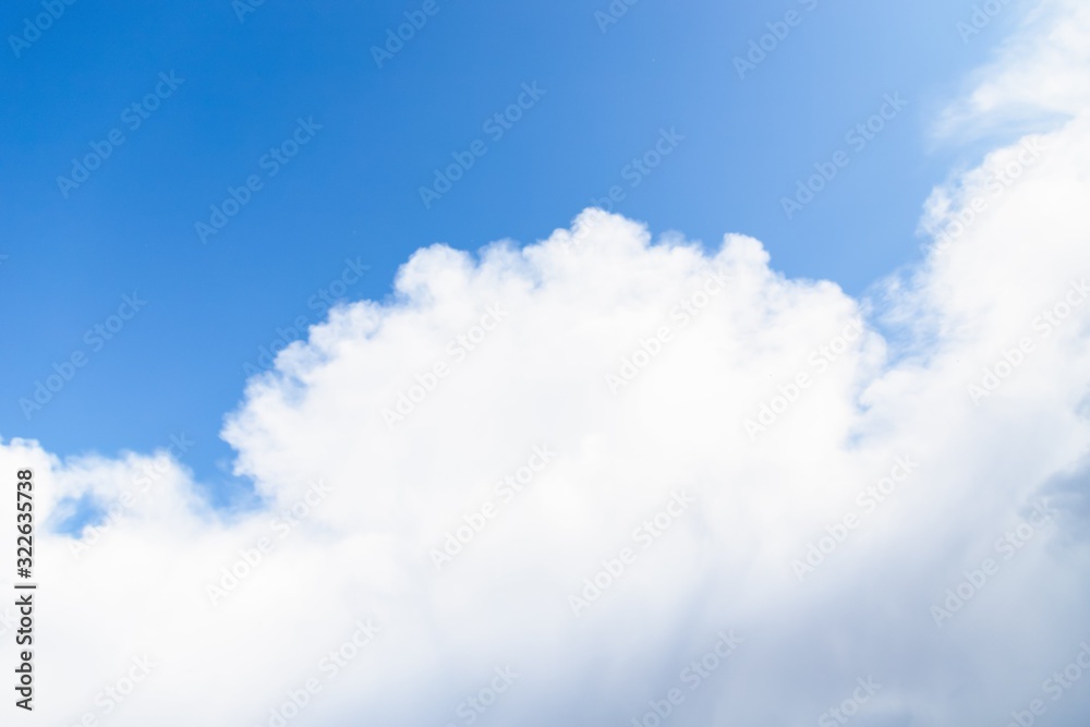 Beautiful white big soft fluffy cloud on a clear blue sky background Beautiful white big soft fluffy cloud on a clear blue sky background