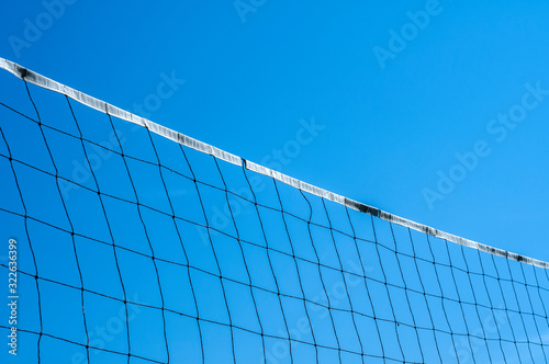 Beach volleyball net closeup on clear blue sky abckground