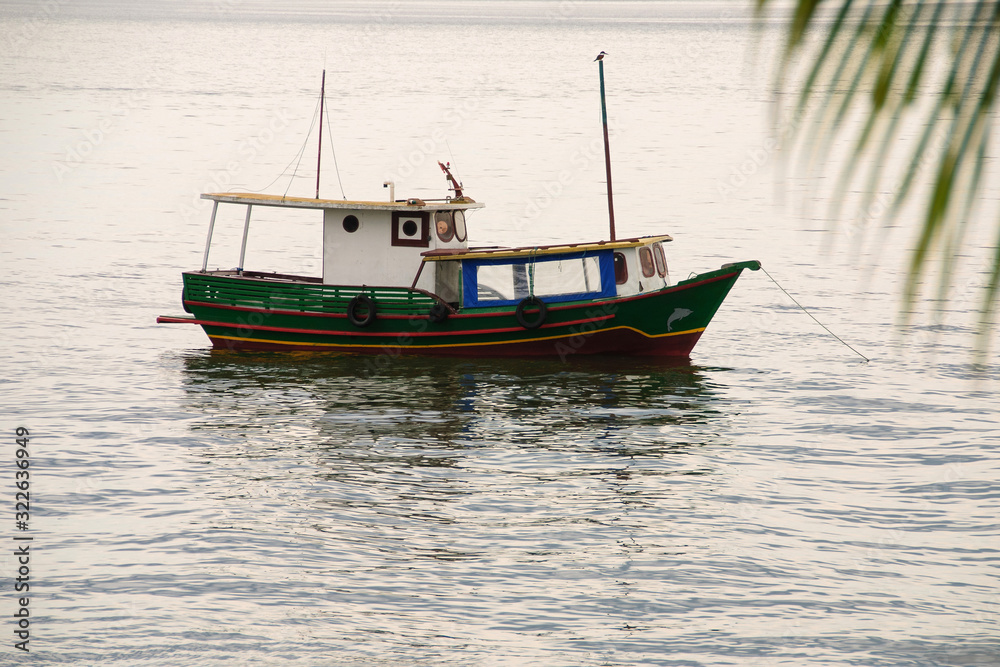 hing boats anchored in the river, floating peacefully in harbor. hing boats anchored in the river, floating peacefully in harbor.