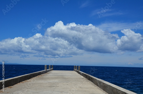  pier stretches to the sea of against blue sky