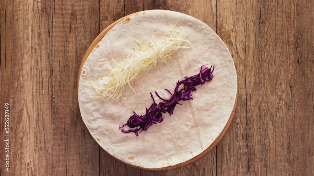 Making a kebab or gyros - a traditional roll sandwich wrapped in wheat flour wraps and various fresh ingredients - top view, flat lay