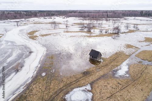 Aerial view of a house surrounded by water with snow Tipu, Viljandi County, Estonia photo