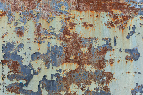 Rusty background. Old rusty metal sheet. rusted wall of the garage. Brown background. Grunge texture.