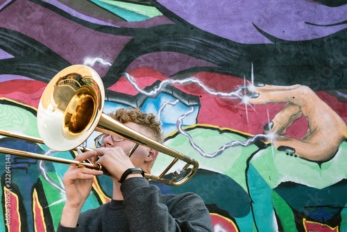 High school jazz band trombone player by colorful graffiti