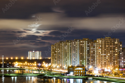 Modern city in the night with lights and clouds