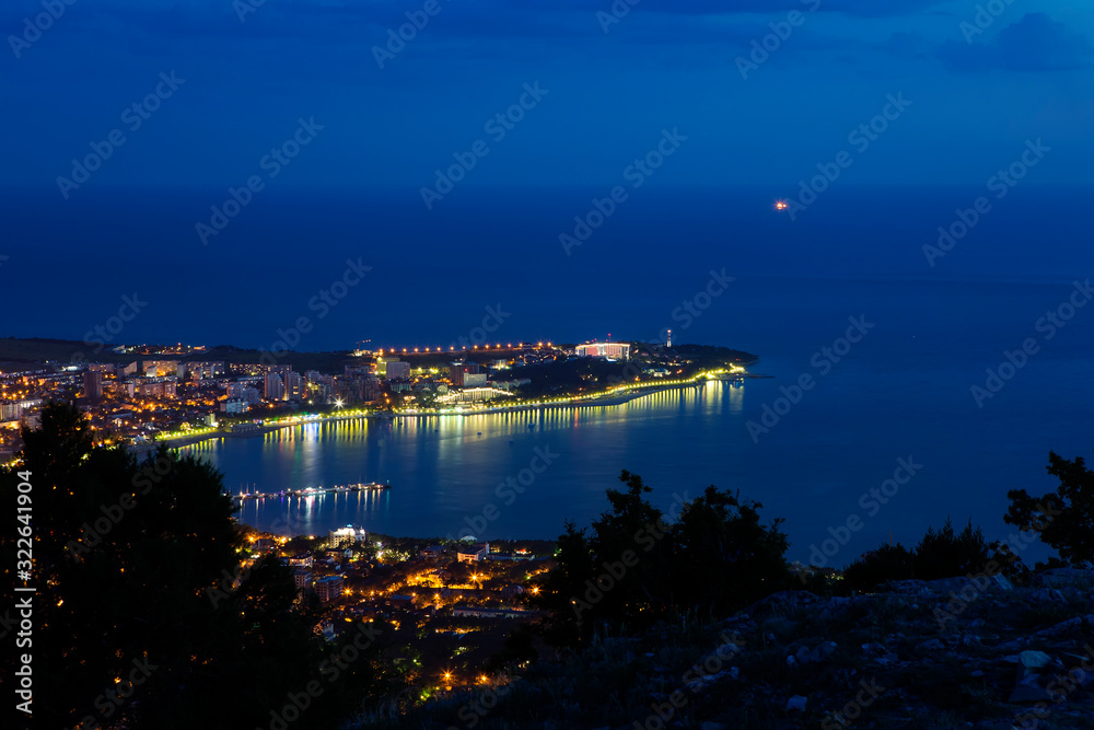 Gelendzhik Bay, Thick Cape and Gelendzhik lighthouse in the evening twilight from a bird's eye view.  lights of the embankment are reflected in the Bay.