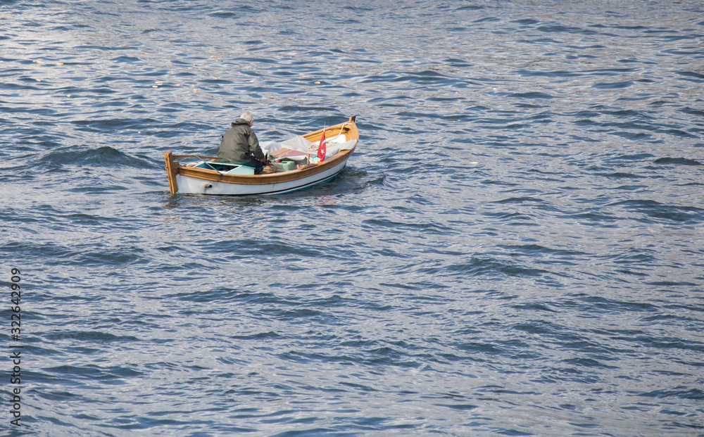 Fototapeta premium Boat close-up on the sea. An old person on the boat.