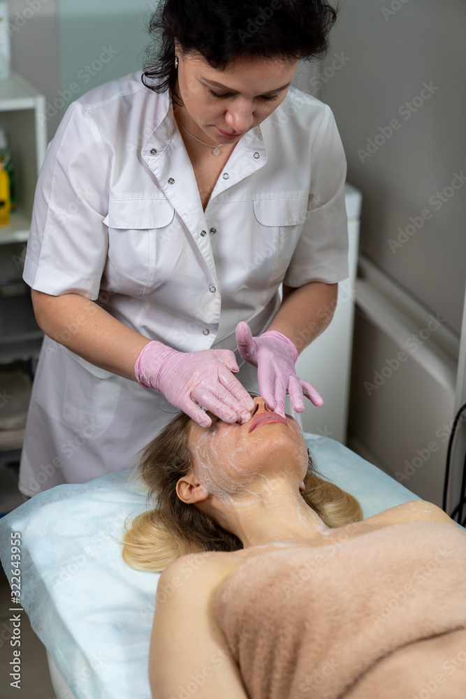 Beautician makes a procedure for a girl to improve facial skin condition Beautician makes a procedure for a girl to improve facial skin condition