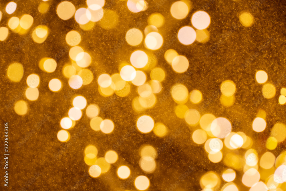 Christmas and Happy new year on blurred gold bokeh banner background.