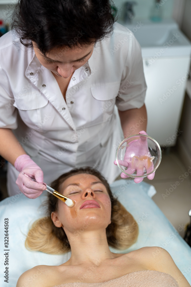 Beautician makes a procedure for a girl to improve facial skin condition Beautician makes a procedure for a girl to improve facial skin condition