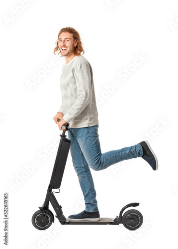 Young man with kick scooter...
