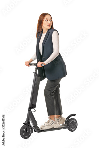 Young woman with kick scoot...
