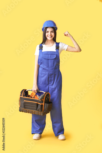 Female worker against color...