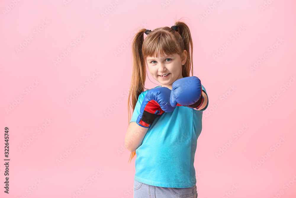 Little girl in boxing gloves on color background. Concept of feminism Little girl in boxing gloves on color background. Concept of feminism