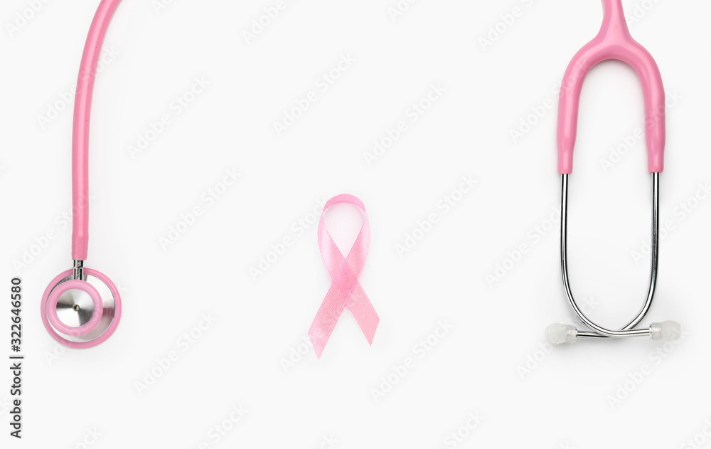 Fototapeta premium Pink ribbon with stethoscope on white background. Breast cancer awareness concept