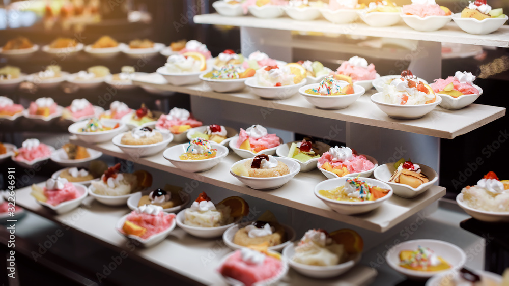 Delicious reception candy bar dessert table. Pieces of sweets cake dessert on a plate.
