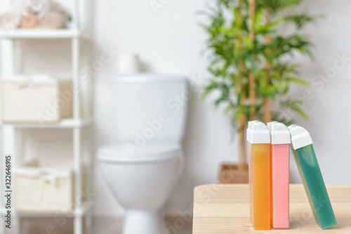 Liposoluble wax cartridges on table in bathroom