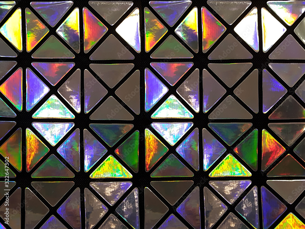 Graphic pattern in the form of a mosaic of triangles with a shiny glossy surface in neon colors. Concept background, abstraction Graphic pattern in the form of a mosaic of triangles with a shiny glossy surface in neon colors. Concept background, abstraction