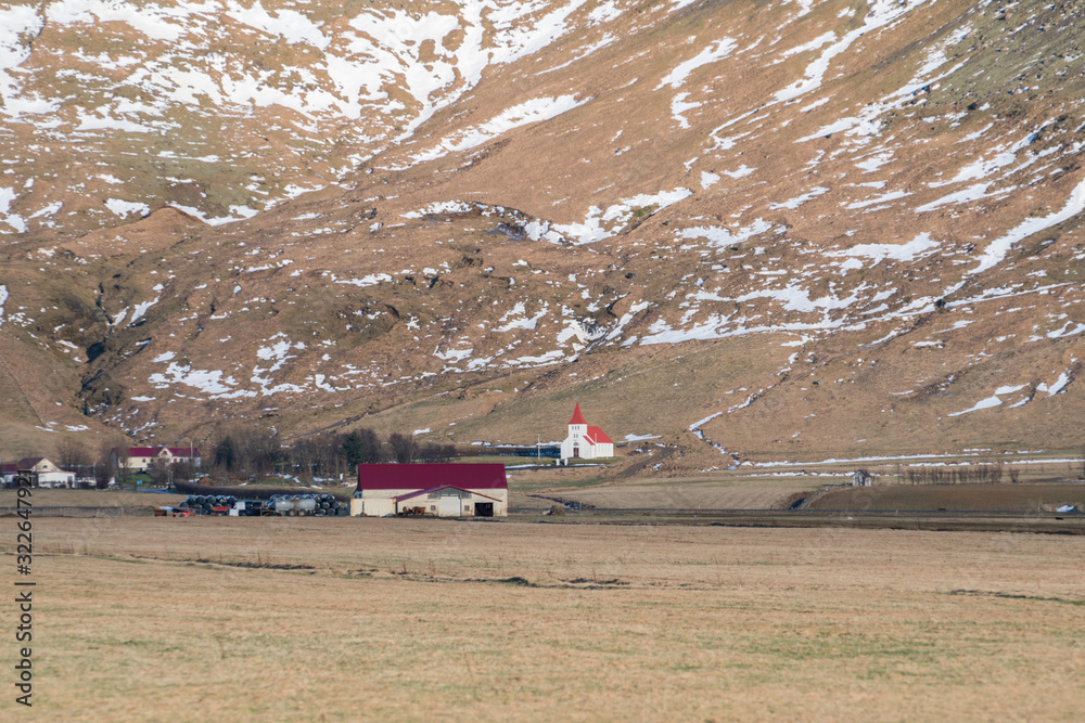 Grassland and small wooden farm houses in winter in Iceland