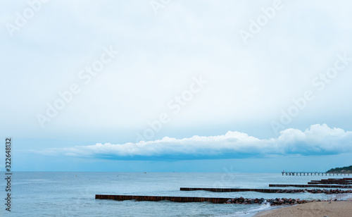 landscape  the blue sky with low clouds merges with the blue sea with breakwaters. can be used as background. concept of serenity  calm