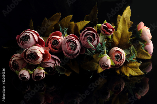 bouquet of natural flowers of a rose on a dark background, a gift for the holiday, close-up
