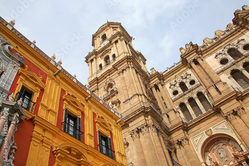 Looking up to the clock tower of the cathedral from the street level. Beautiful architecture & a historic monument, Malaga,  Andalusia, Southern Spain.