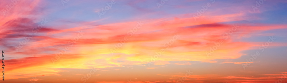 Beautiful red and orange cloud formations at sunrise in  a panorama sky view - obrazy, fototapety, plakaty 