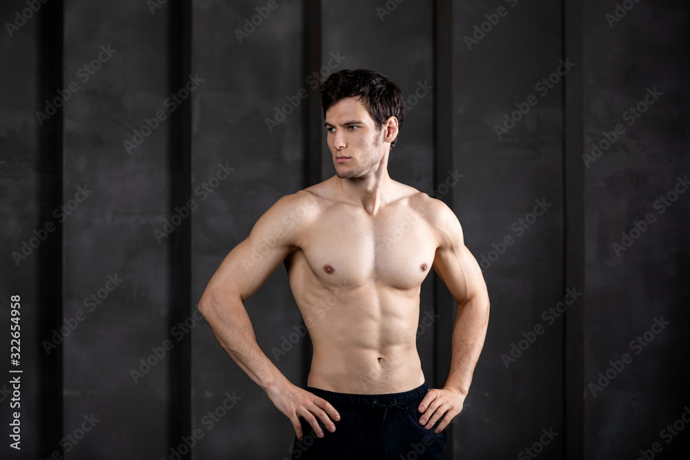 Fototapeta premium Portrait of muscular guy posing in a studio.