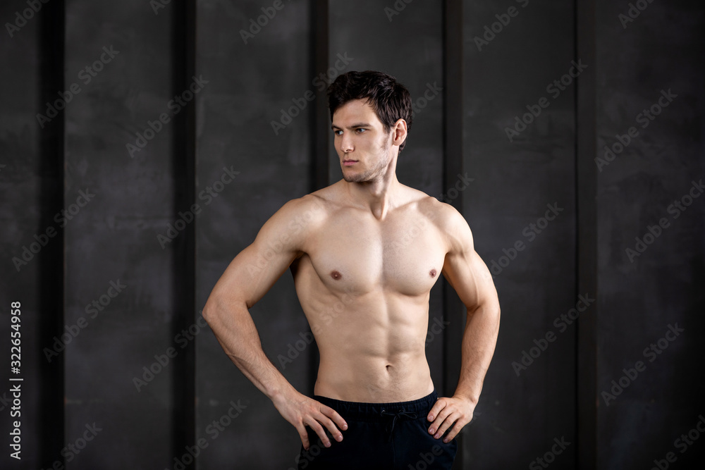 Portrait of muscular guy posing in a studio.