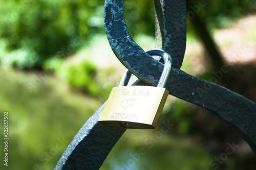 Love lock locks hang from a bridge