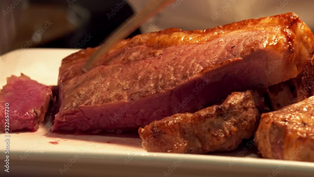 Chef cutting steak close up medium raw Chef cutting steak close up medium raw