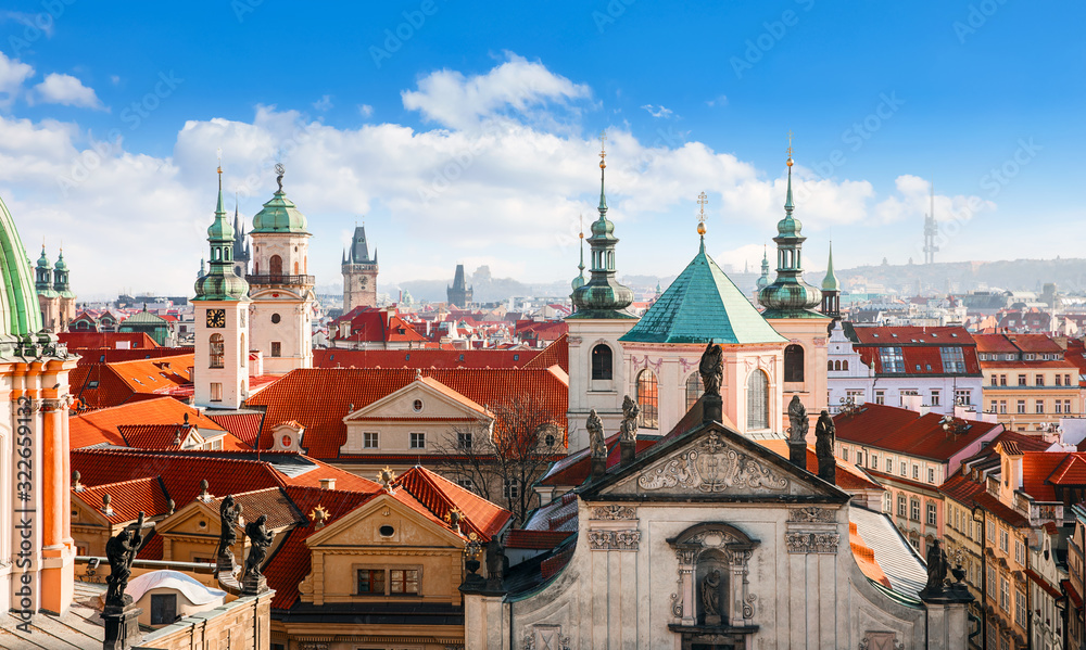 Prague Czech Republic. View at old town from tower at Charles Bridge. Picturesque landscape. Panorama landmark with broach and sculptures at cathedral. Red tegular roof of Europe.