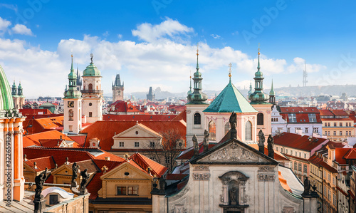 Prague Czech Republic. View at old town from tower at Charles Bridge. Picturesque landscape. Panorama landmark with broach and sculptures at cathedral. Red tegular roof of Europe.