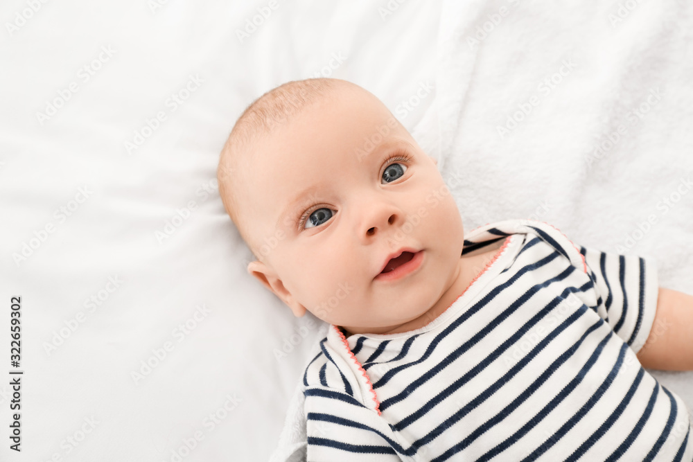 Portrait of cute little baby lying on bed Portrait of cute little baby lying on bed