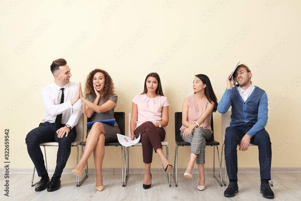 People looking at happy couple who has successfully passed job interview People looking at happy couple who has successfully passed job interview