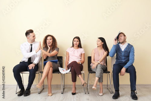 People looking at happy couple who has successfully passed job interview