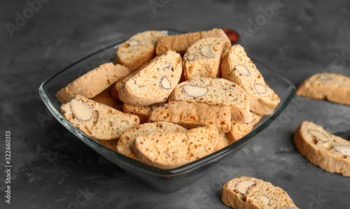 Bowl with sweet almond cookies on table