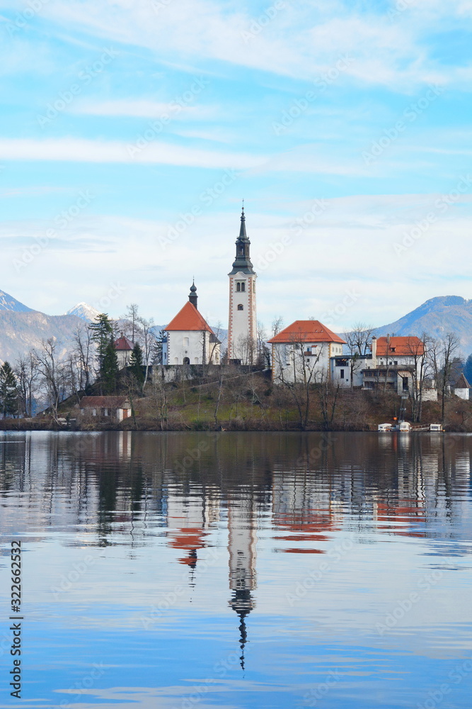Lake Bled Slovenia. Beautiful mountain lake with small Pilgrimage Church. Most famous Slovenian lake and island Bled with Pilgrimage Church of the Assumption of Maria and Bled Castle in background.