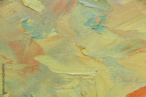 Textured background of oil paint in yellow tones, selective focus
