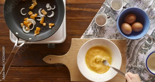 Top view food. Cooking With Mother. Beautiful Little Girl Learns How To Make Fried Egg.