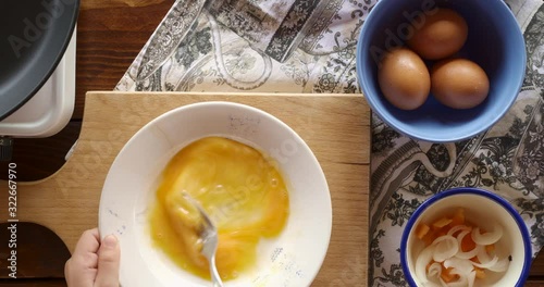 Top view food. Cooking With Mother. Beautiful Little Girl Learns How To Make Fried Egg.
