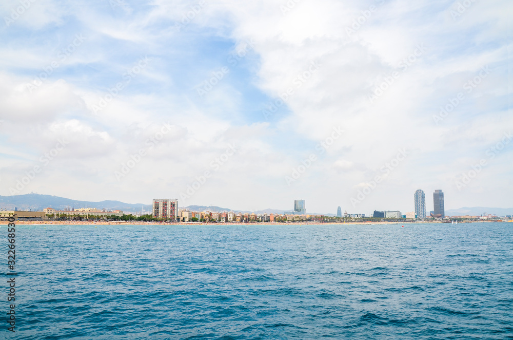 Barcelona from Mediterranean sea. Maritime facade of the city of Barcelona with barceloneta beach on first term and city building behind, Catalonia, Spain