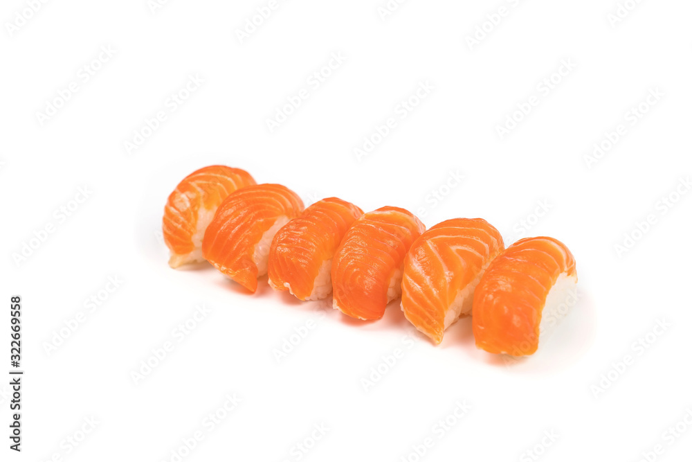 a Group of Sushi Salmon in the row on the whire background. This it the traditional Japanese food eat between raw fresh salmon and rice.