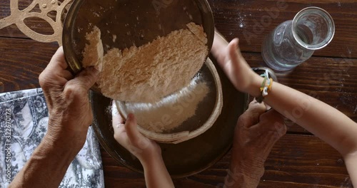 Top view preparing food. Cooking With Grandma. Beautiful Little Girl Learns How To Make Cookies.