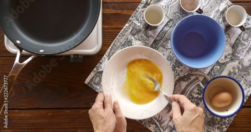 Top view food. Cooking With Mother. Beautiful Little Girl Learns How To Make Fried Egg.