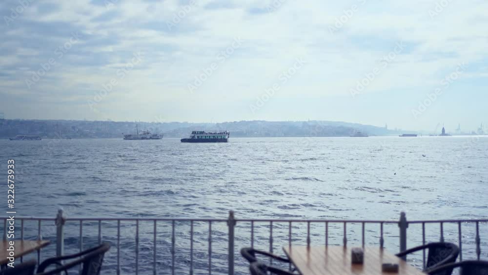 the cafe tables near the sea with ships and waves the cafe tables near the sea with ships and waves