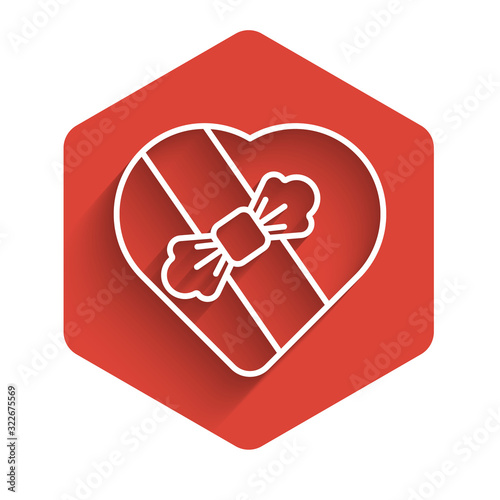 White line Candy in heart shaped box and bow icon isolated with long shadow. Valentines Day. Red hexagon button. Vector Illustration