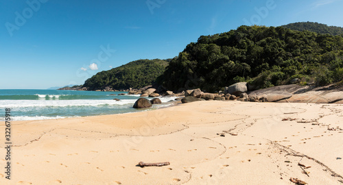 Fototapeta Naklejka Na Ścianę i Meble -  Panoramic view Beautiful Parnaioca beach with crystal clear blue water and stones, deserted tropical beach in the sunny Coast of Rio de Janeiro, Ilha Grande in the city of Agnra dos Reis, Brazil