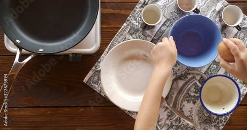 Top view food. Cooking With Mother. Beautiful Little Girl Learns How To Make Fried Egg.